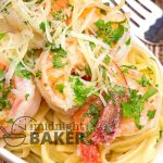 Delicious garlicky shrimp scampi served with a bed of pasta in an olive oil and butter herb sauce