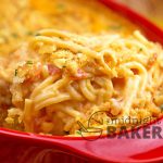 Cheesy chicken spaghetti casserole with spicy rotel tomatoes in the sauce.