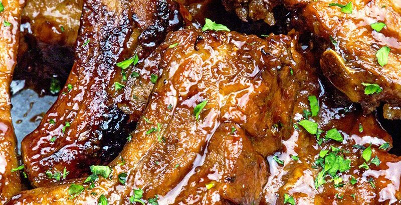 Succulent pork back ribs cooked in beer and coated with a special roadhouse sauce! Guy pleasing food at it's best!!