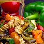 Whole wheat pasta salad full of roasted bell peppers and other veggies with a balsamic dressing to die for!
