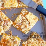 These peach pie bars have the added accent of cheesecake dolloped on top!